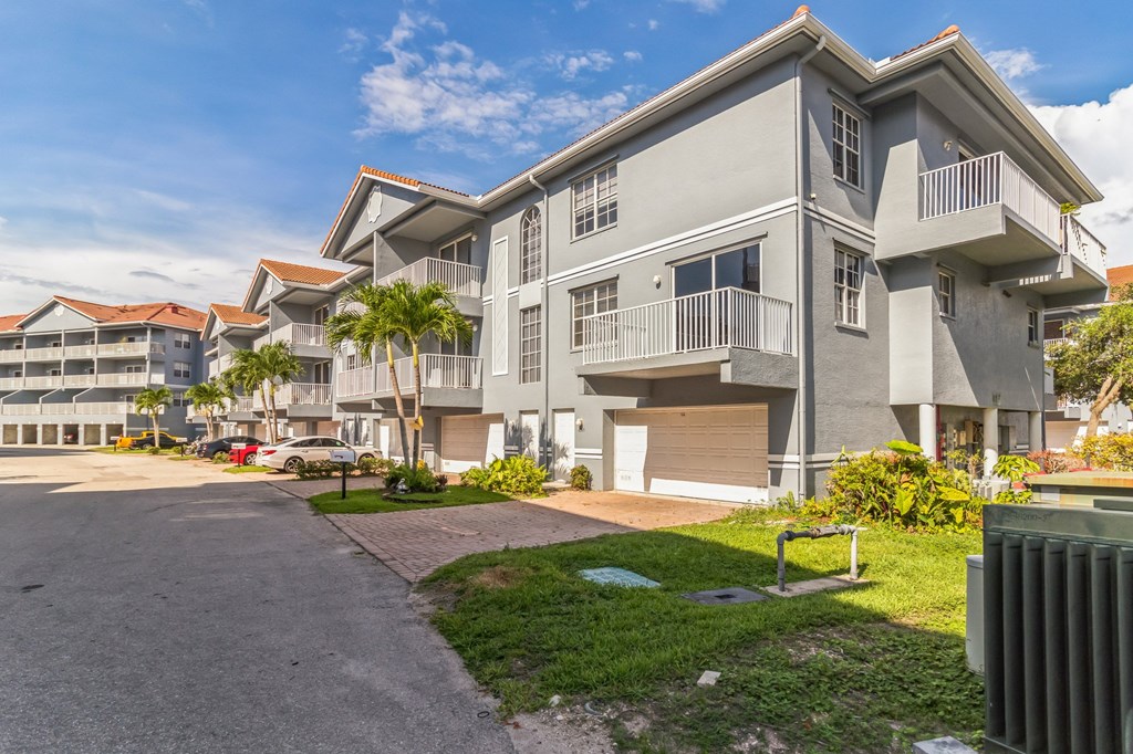 Building exteriors with view of corner apartment unit patios