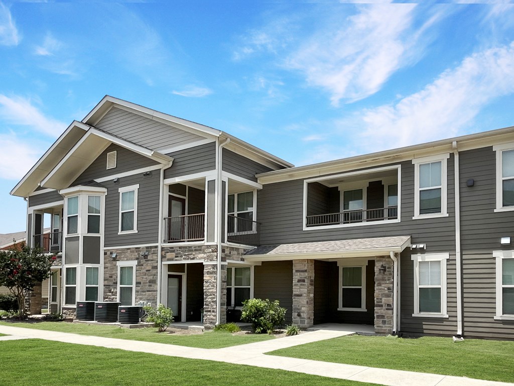 Two story garden style community with paved walkways and private patios