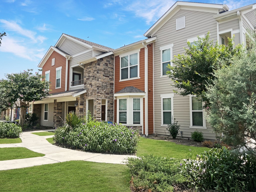 Exterior building with lush landscaping and walking path