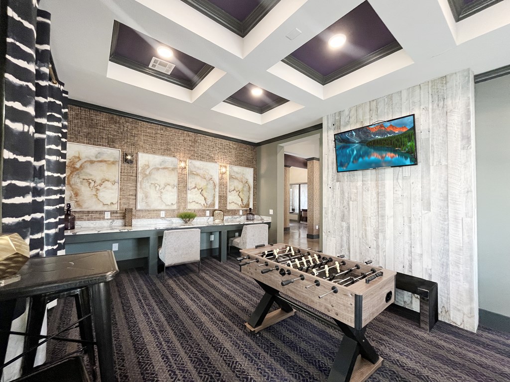 Resident lounge with a game room with a foosball table and shuffleboard