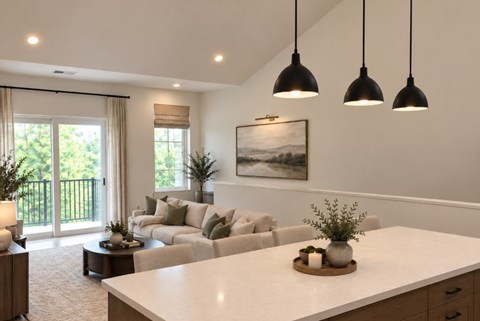 A modern living room with a large white sofa and a coffee table in the center.