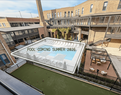 A pool is being built in a courtyard surrounded by buildings.