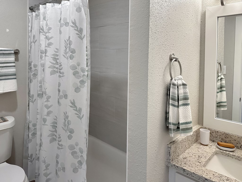 a bathroom with a shower and a sink