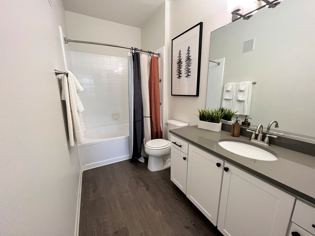 a bathroom with a toilet sink and shower