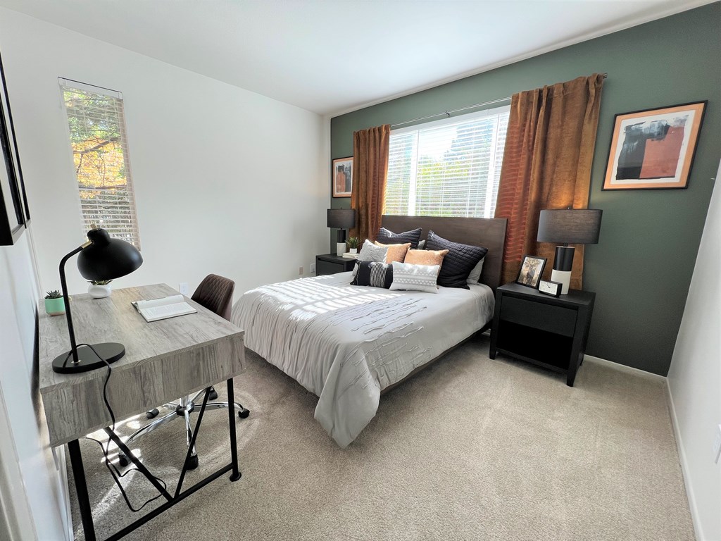 a bedroom with a bed and a desk