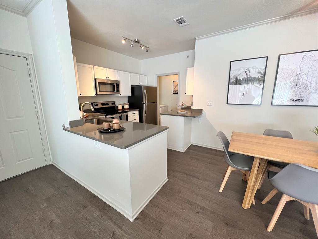 a kitchen and dining area in a 555 waverly unit