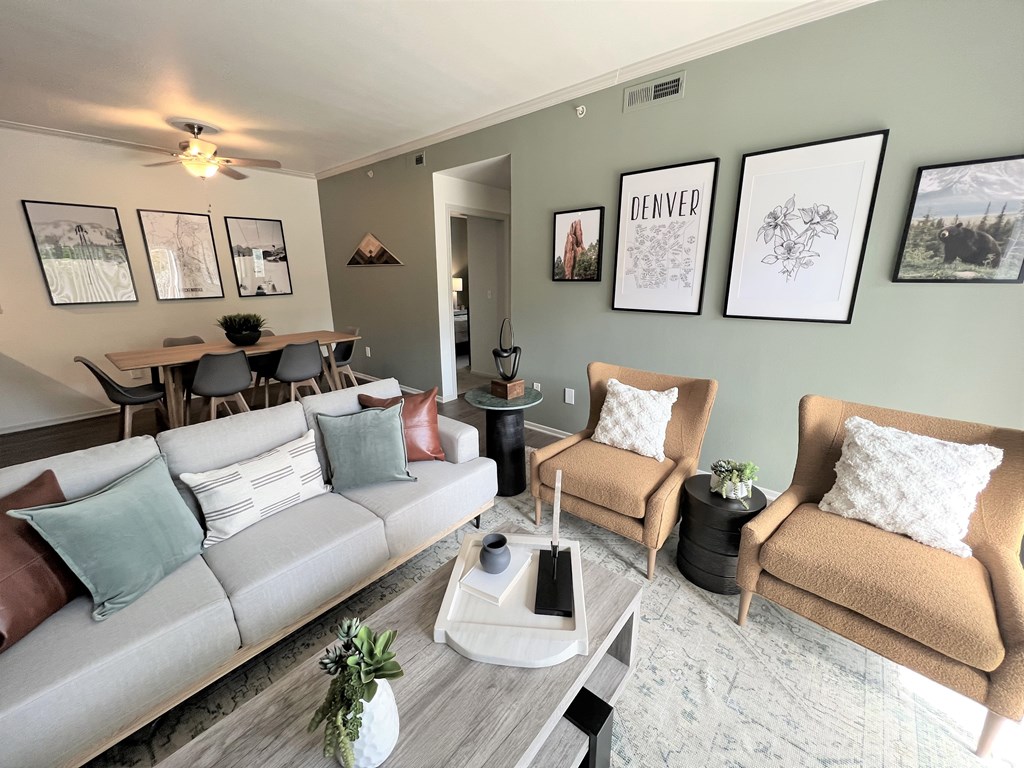 a living room filled with furniture and a large window