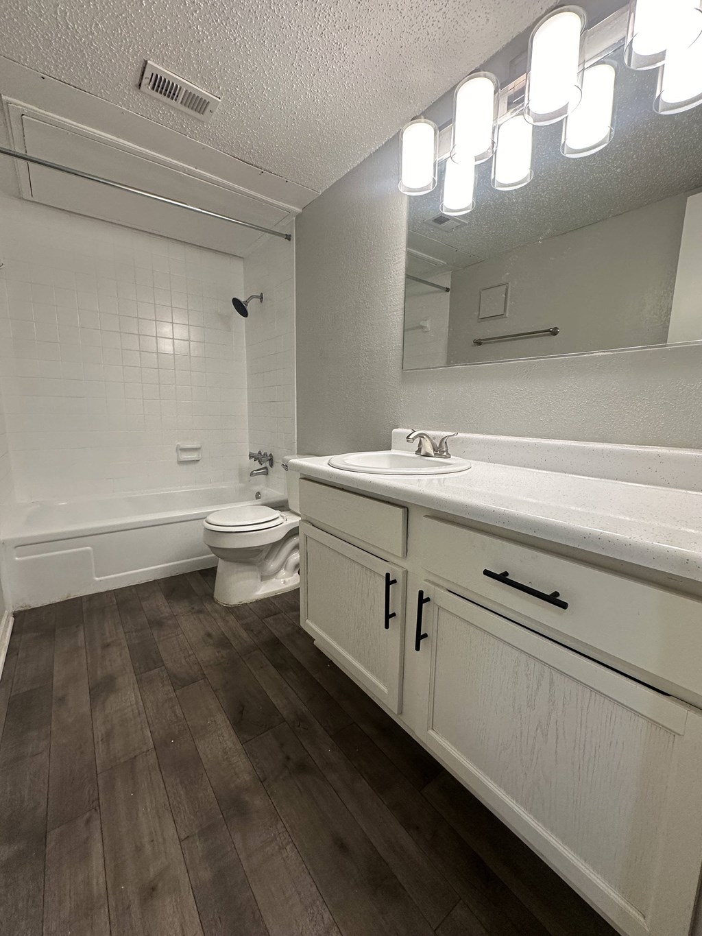 a bathroom with a toilet and a sink and a mirror