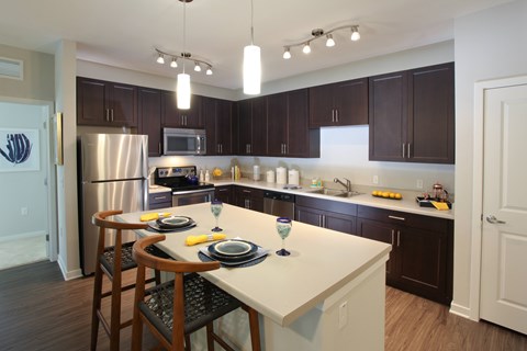 A kitchen with a table set for two.
