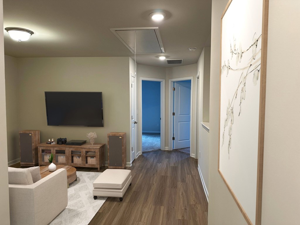 a living room with a tv and a door to a hallway