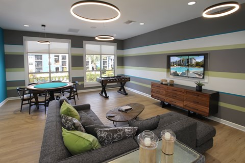 A modern living room with a pool table and a television.