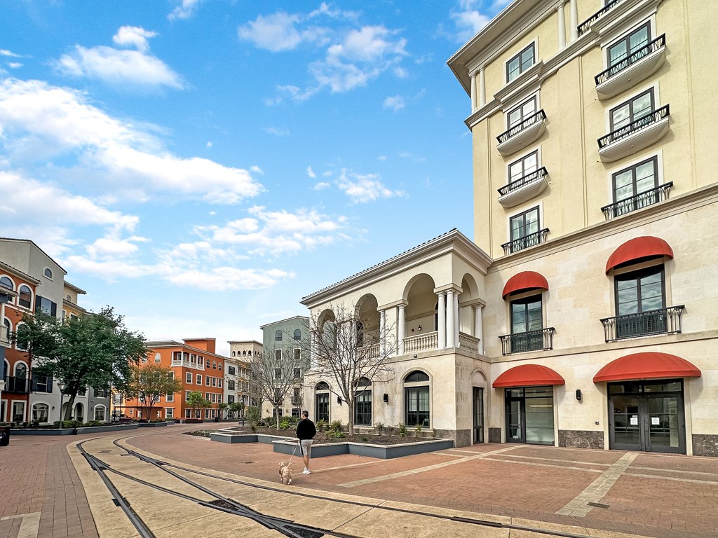 a person walking a dog in front of a building