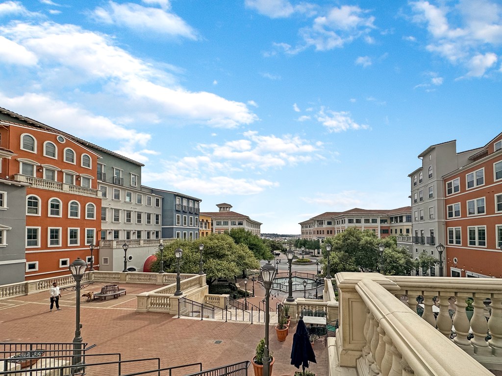 a view of a city street with buildings and a fountain
