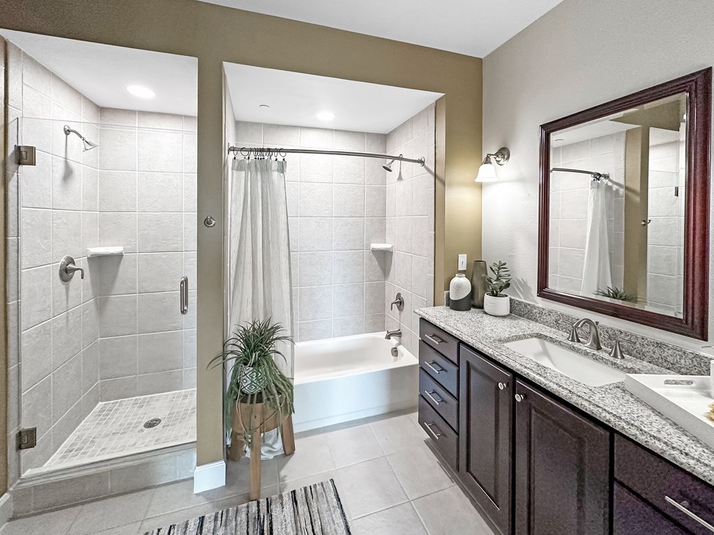 a bathroom with a shower and a sink and a mirror