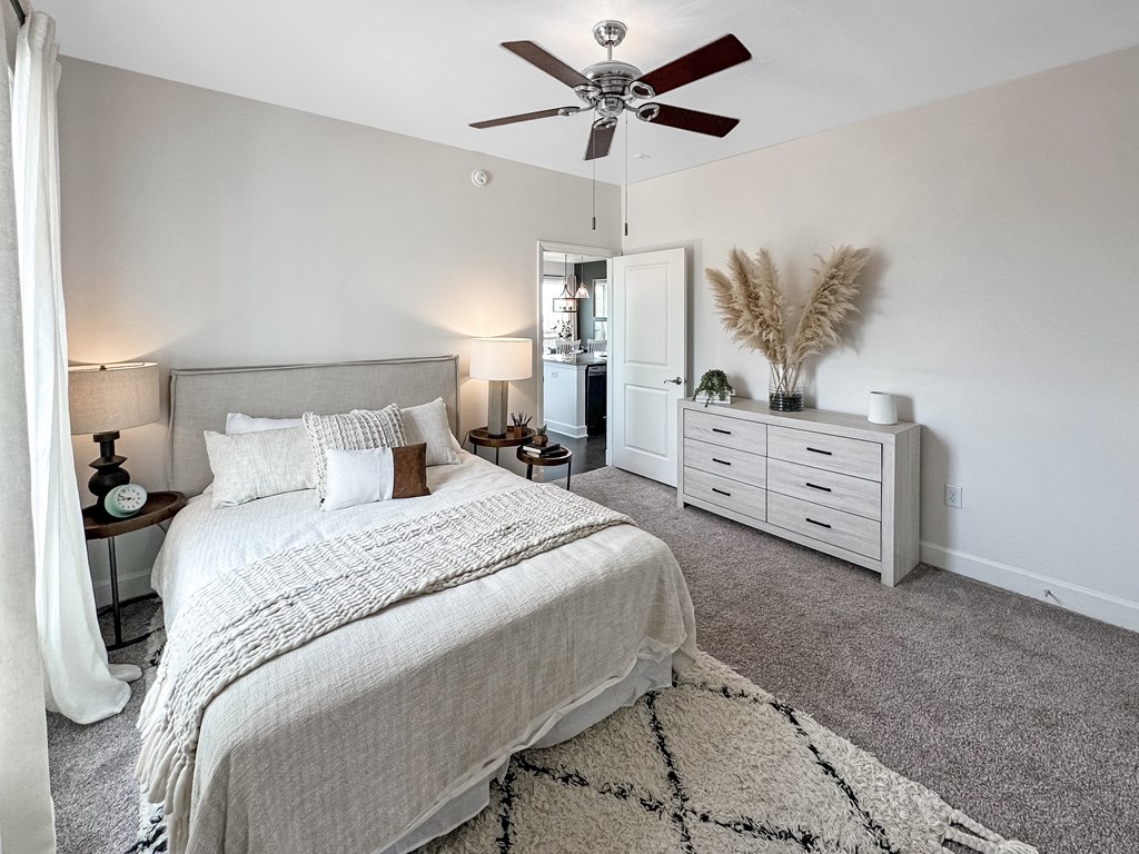 a bedroom with a bed and a ceiling fan