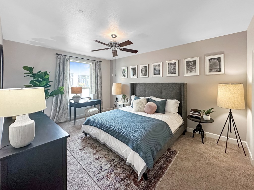 a bedroom with a bed and a ceiling fan