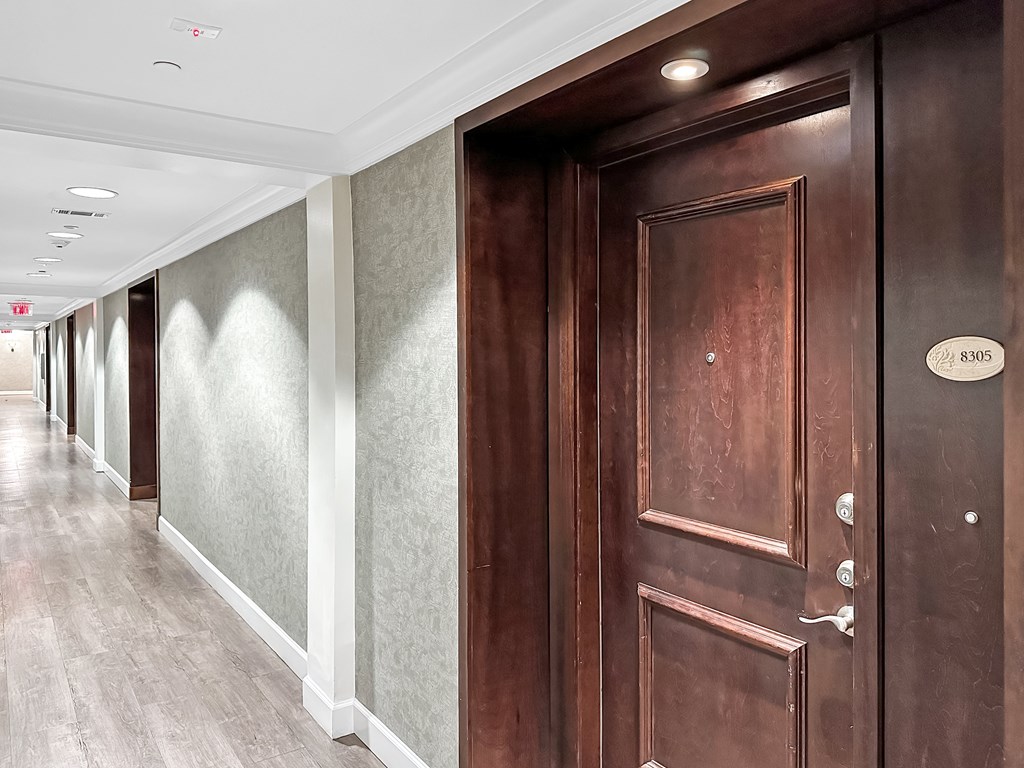 a hallway with wooden doors in a building