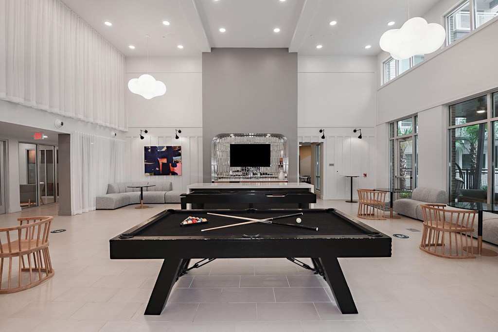 a large living room with a pool table and a television