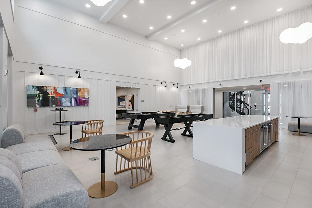 a game room with a pool table and tables