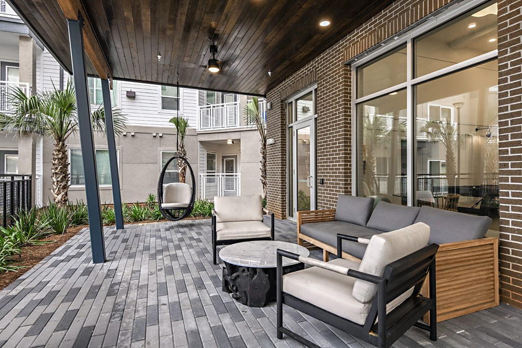 a patio with a couch and chairs and a table