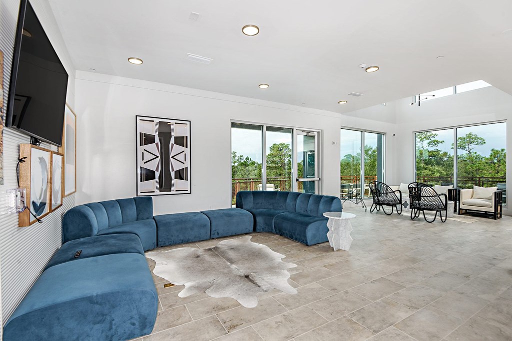 a living room with blue couches and a tv