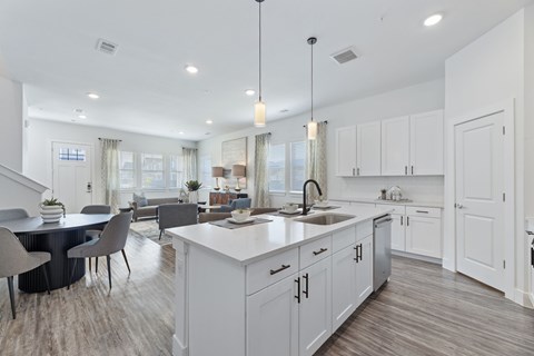 A modern kitchen with a dining table and chairs.