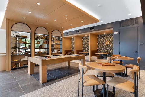 A modern dining area with a long table and chairs.