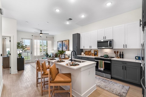 A modern kitchen with a dining table and chairs.