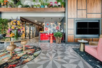 a lobby with colorful flowers and a television