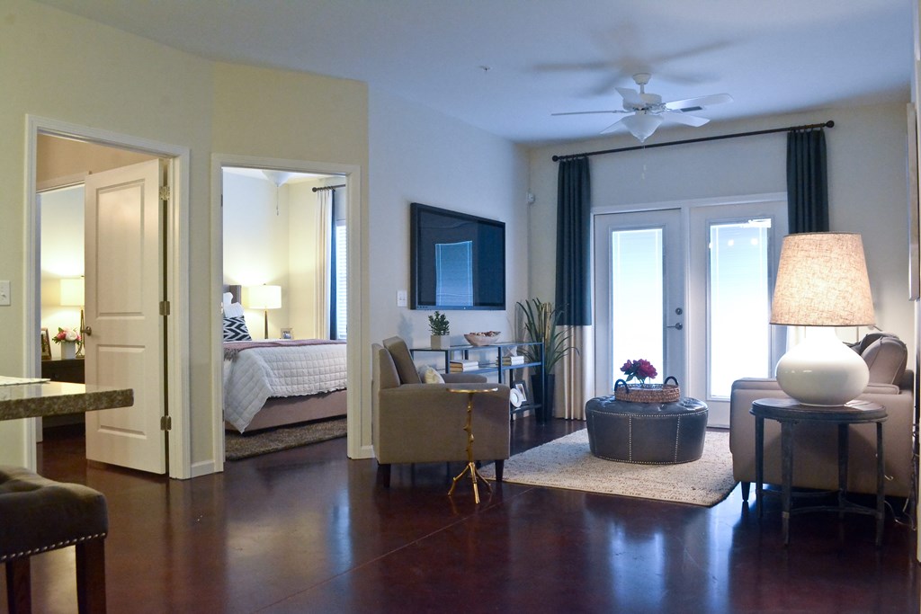A well lit bedroom with a bed and a couch.