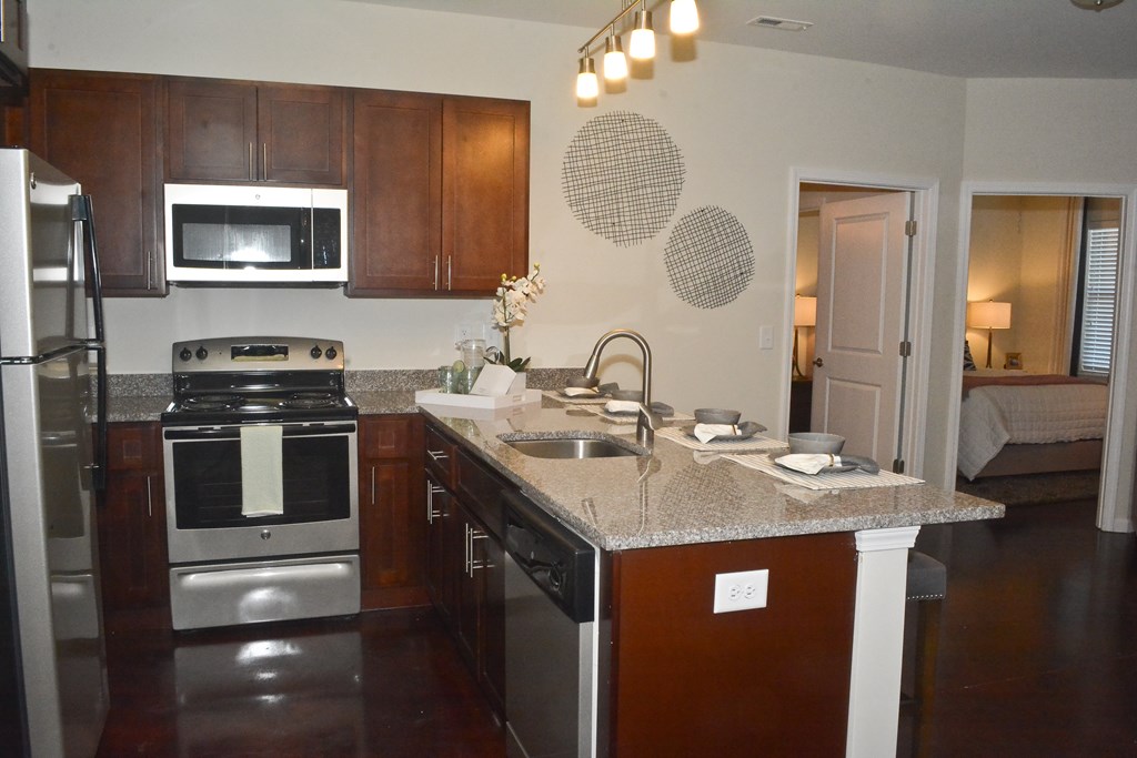 A kitchen with a stove top oven and a microwave.