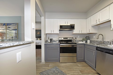 a kitchen with stainless steel appliances and white cabinets