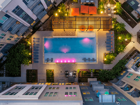 A swimming pool with a pink light in the middle of it.