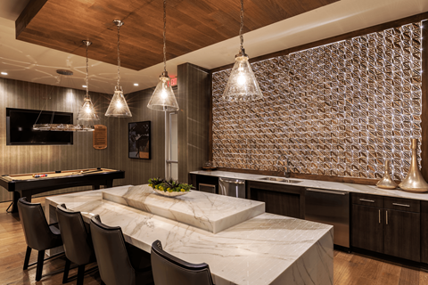 A kitchen with a marble table and a patterned wallpaper.