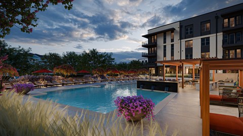 A pool surrounded by a building and trees.