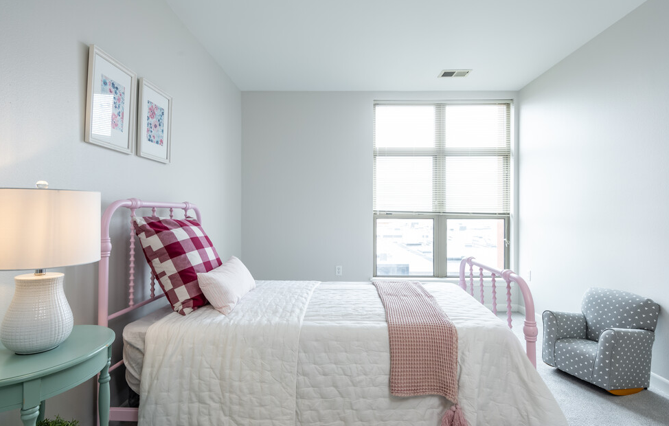 a bedroom with a bed in a room