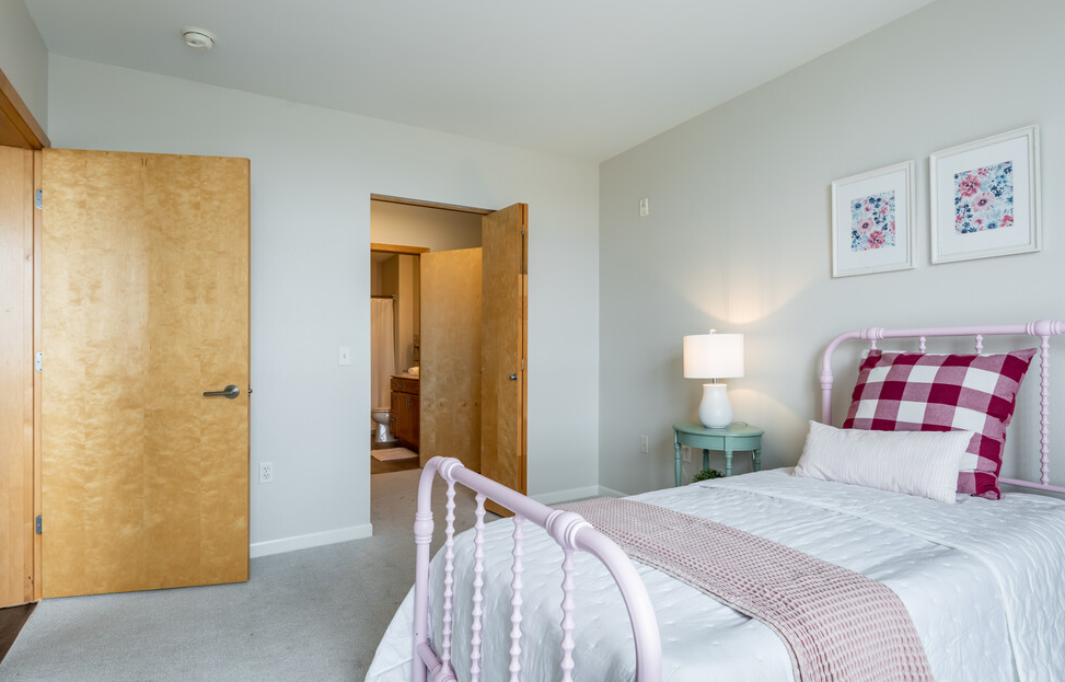 a bedroom with a bed in a room