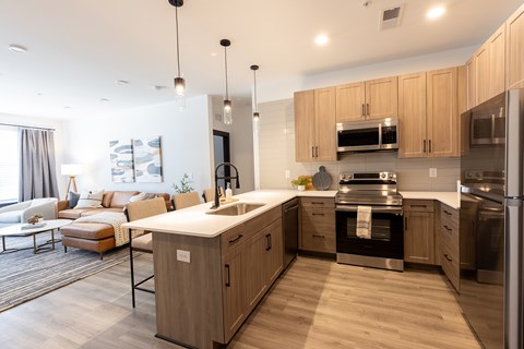 A modern kitchen with wooden cabinets and stainless steel appliances.