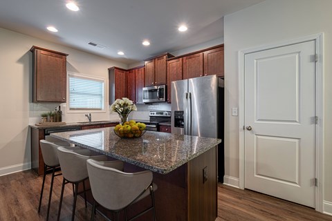 a kitchen with stainless steel appliances and a granite counter top