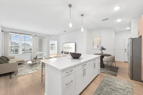 A modern kitchen with white cabinets and a large island.