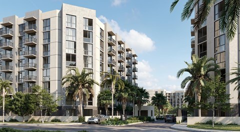 A modern apartment building with balconies and palm trees in front.