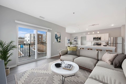 A living room with a grey couch and a coffee table.