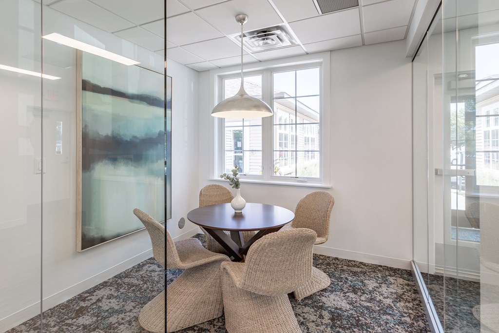 a meeting room with a table and chairs at Lake Susan Apartments in Chanhassen, MN