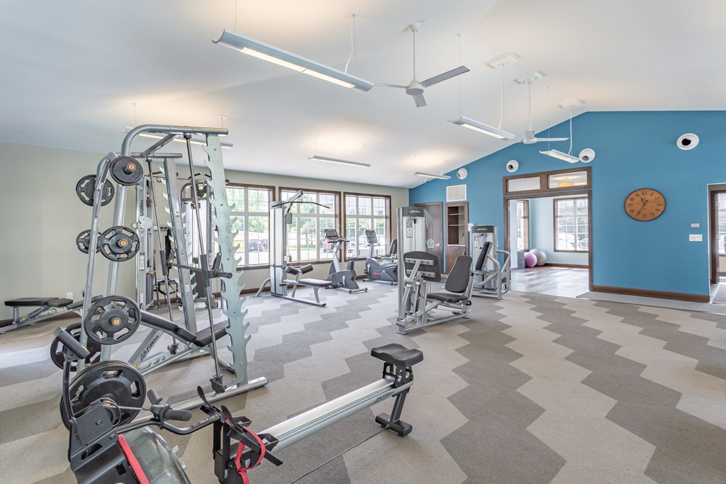 a fitness center with exercise equipment and windows at Lake Susan Apartments in Chanhassen, MN
