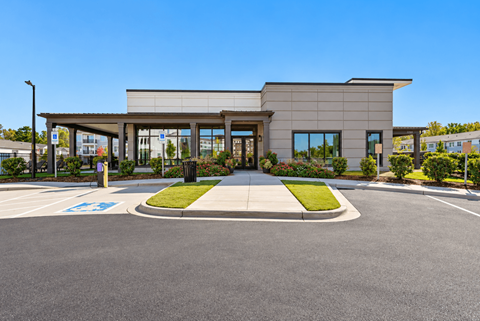 A modern building with a parking lot in front.