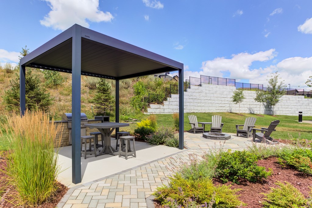 Grill pavilion with covered patio and firepit with Adirondack chairs