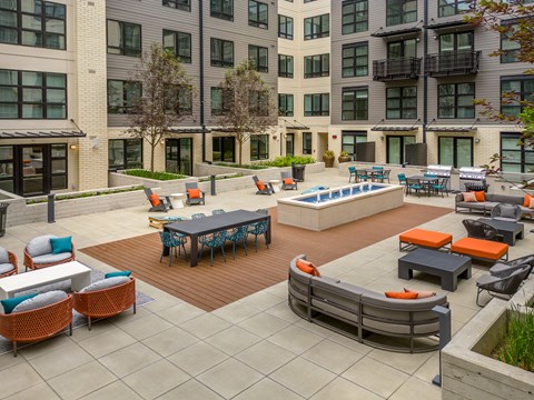 A large outdoor patio area with a pool table and seating.