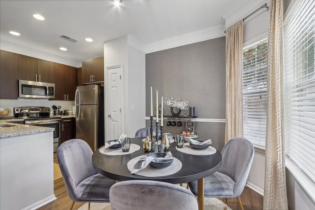 a kitchen and dining room with a table and chairs