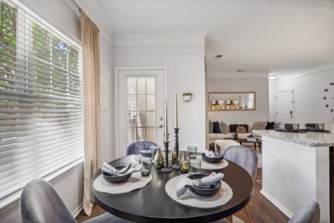 a dining room with a table and chairs