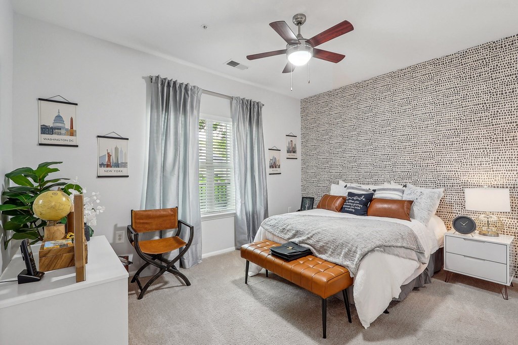 a bedroom with a large bed and a geometric wall paper on the ceiling
